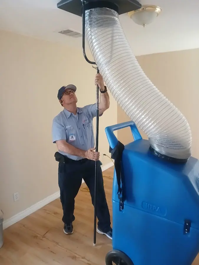 Furnace Tune-Up technician using HEPA equipment in Rochester